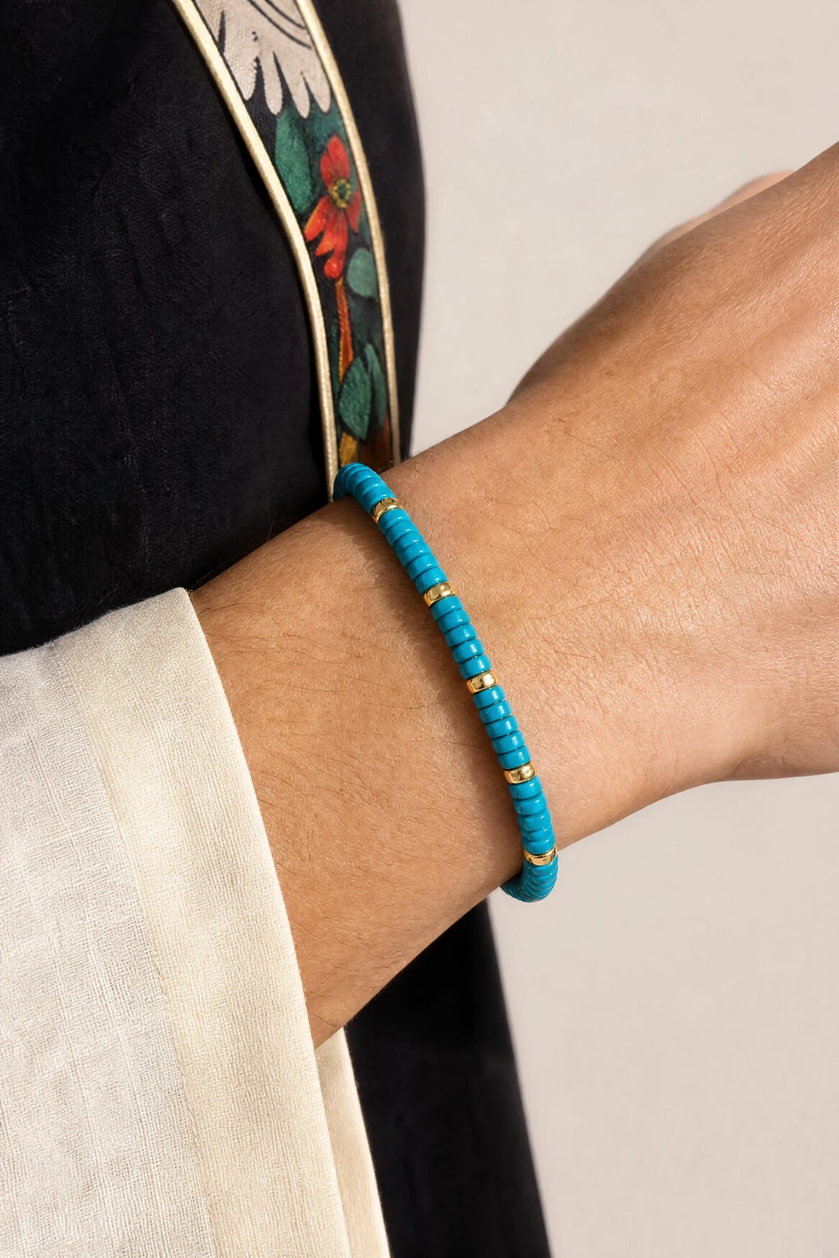 blue-magnesite-flat-bead-bracelet-model-a-outfit-a-closeup-01