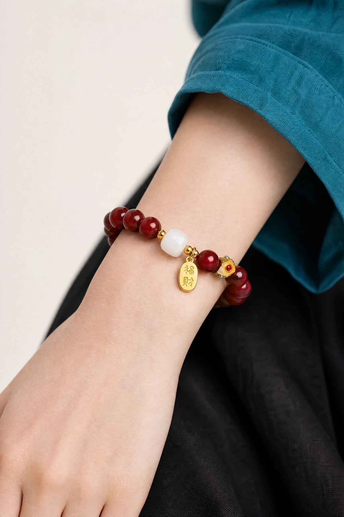 cinnabar-fortune-charm-bracelet-model-a-outfit-a-closeup-01