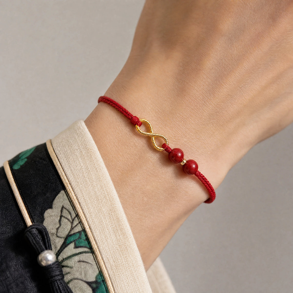 cinnabar-infinity-cord-bracelet-model-a-outfit-a-closeup-01