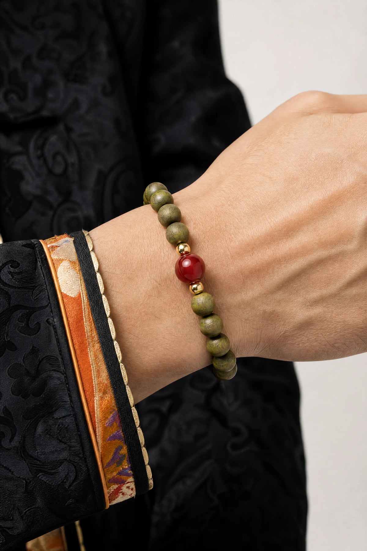 green-sandalwood-cinnabar-mala-bracelet-model-a-outfit-a-closeup-01