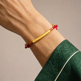 om-mani-padme-hum-red-string-bracelet-model-a-outfit-a-closeup-01