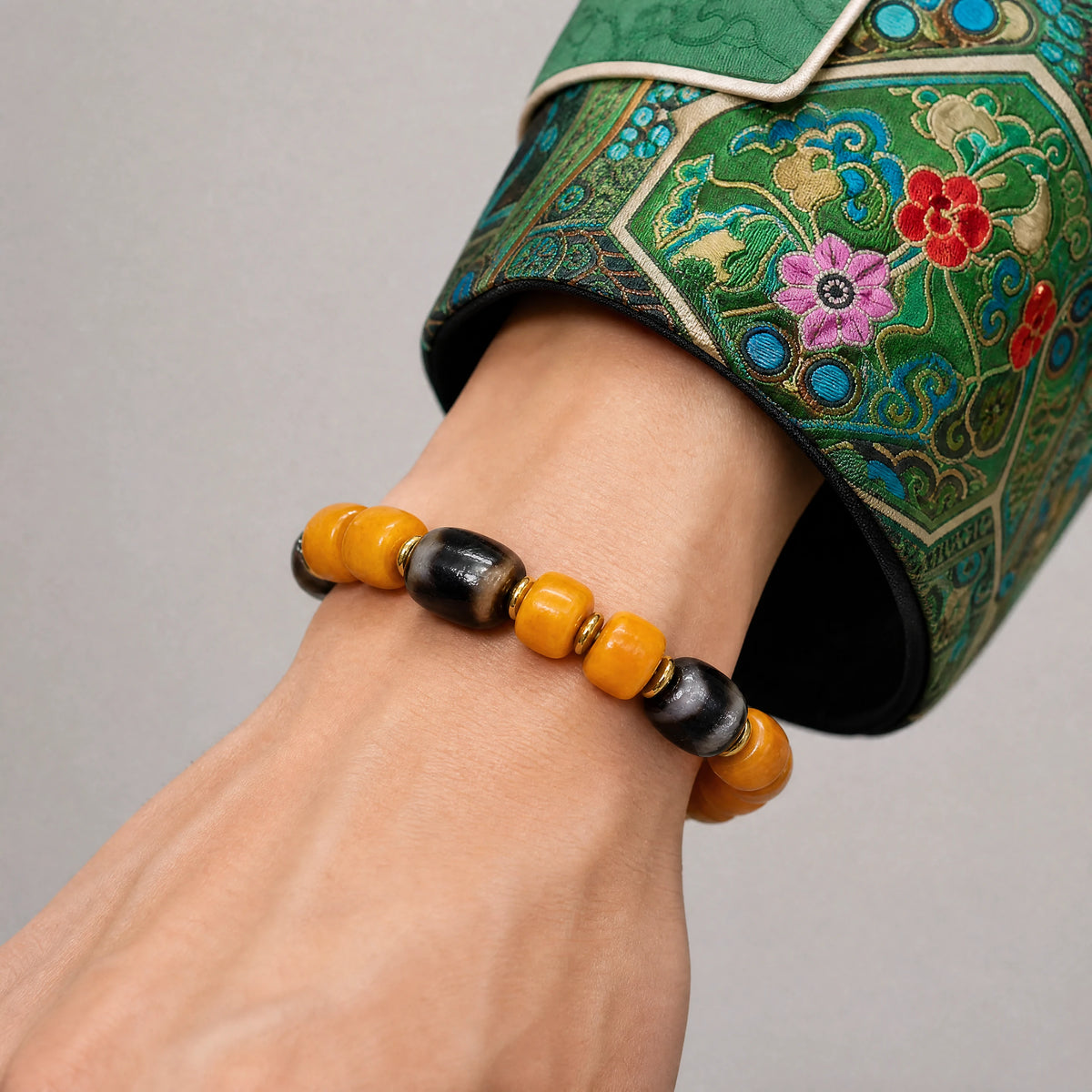 yellow-yak-bone-three-eye-dzi-bracelet-9mm-model-a-outfit-a-closeup-01